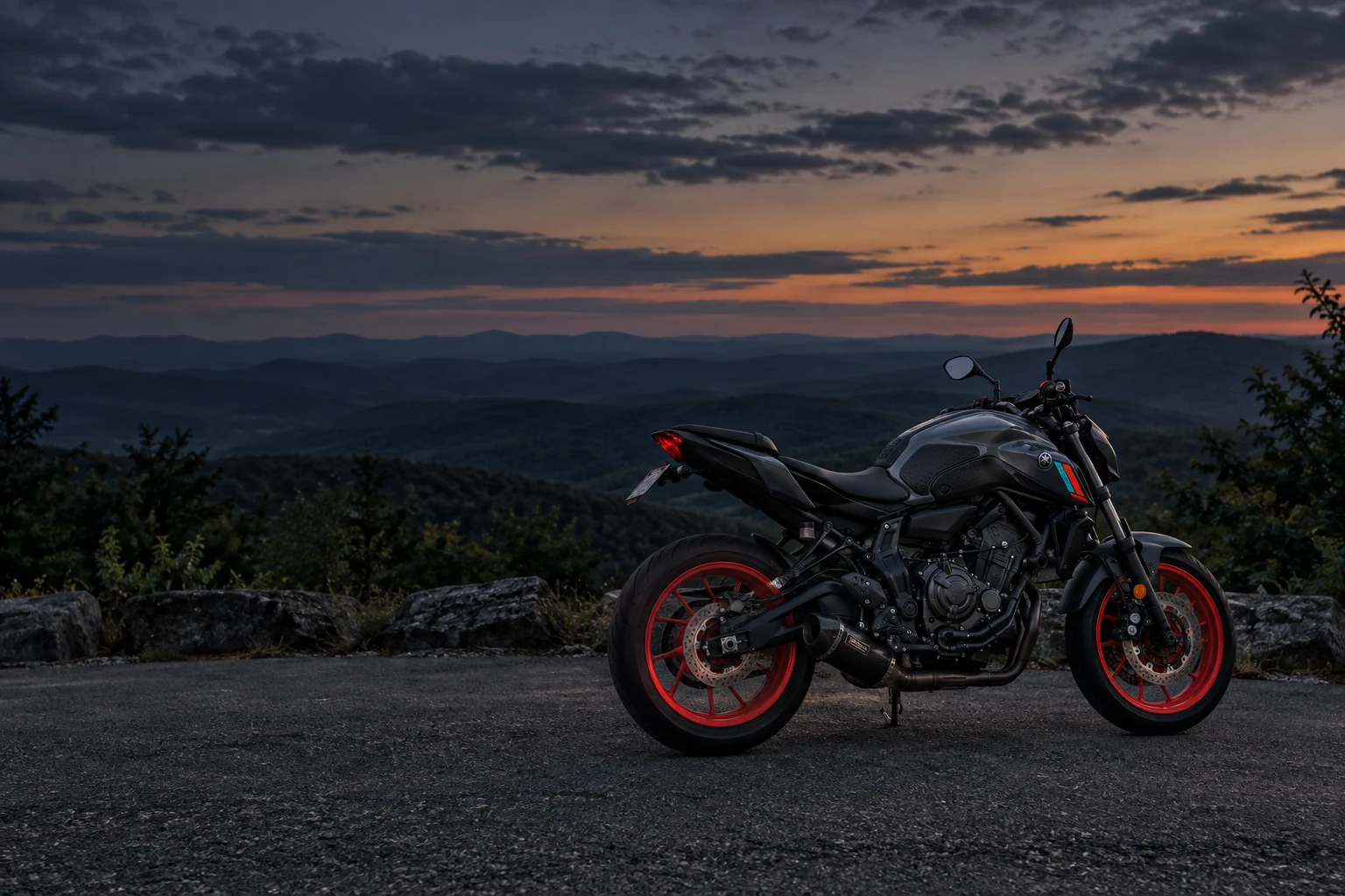 Illustrated concept of a dark gray motorcycle with red wheels against mountains at dusk.